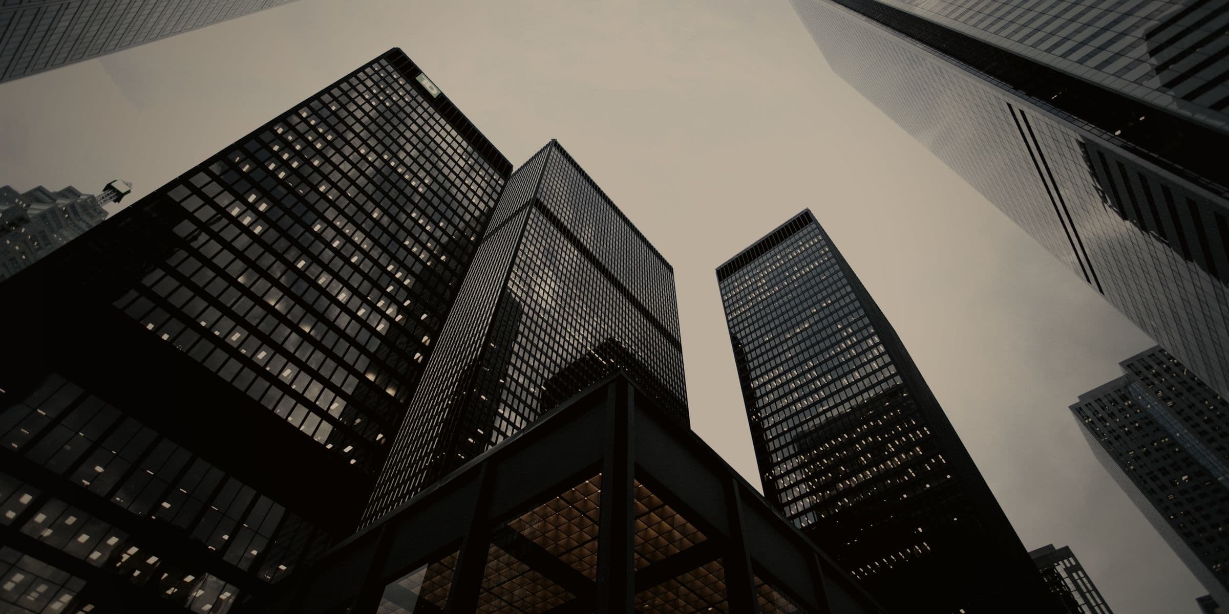 Finlay Realty's residential towers photographed from below at dusk, their glazed facades catching the last of the light.